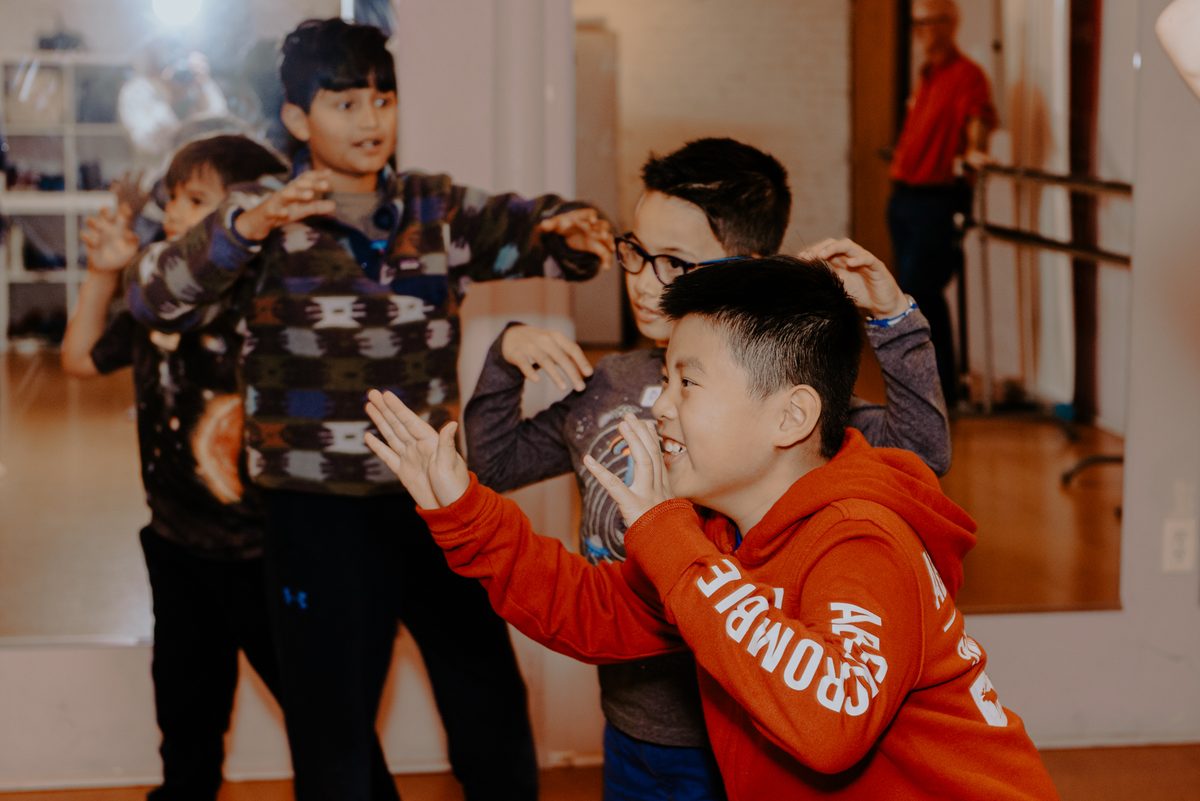 young children making dramatic poses in a music and movement class