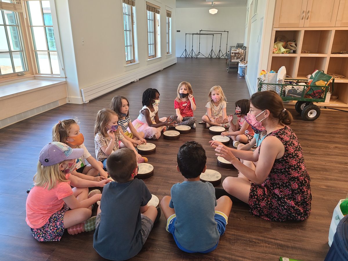 children singing and playing drums in a music class