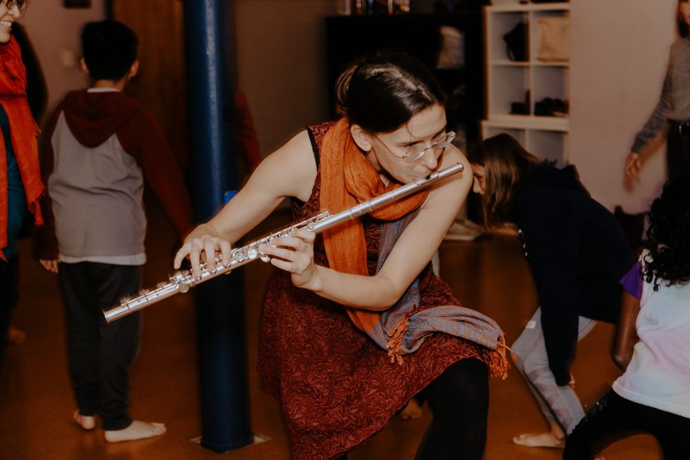 Playing flute at a workshop